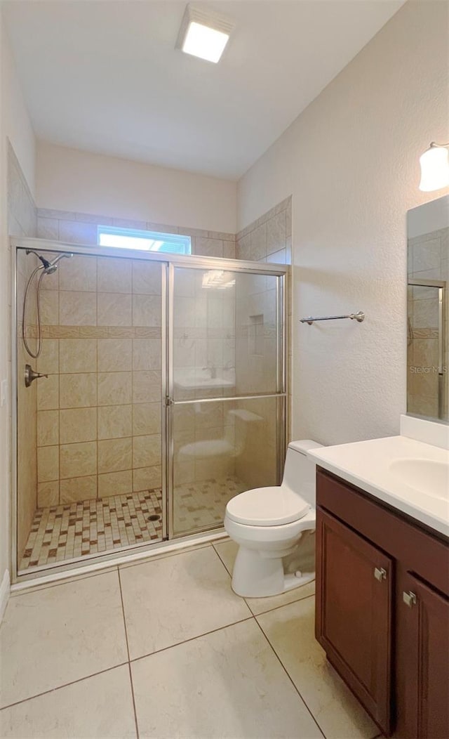 bathroom with toilet, an enclosed shower, vanity, and tile patterned floors