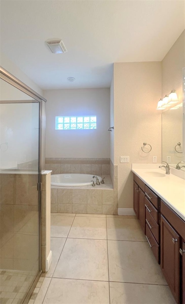 bathroom with tile patterned flooring, vanity, and plus walk in shower