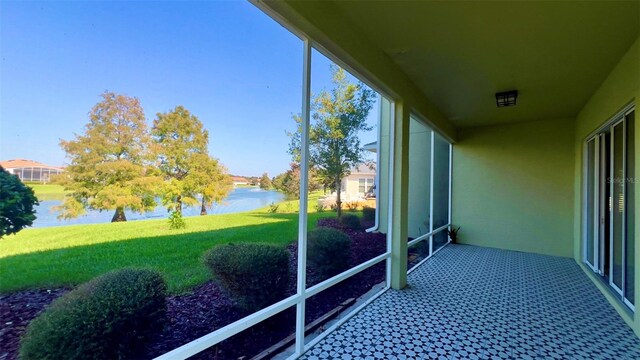 unfurnished sunroom with a water view