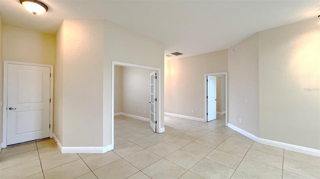 unfurnished room with light tile patterned floors