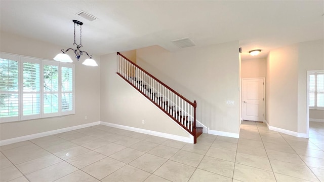 interior space featuring a chandelier and tile patterned flooring