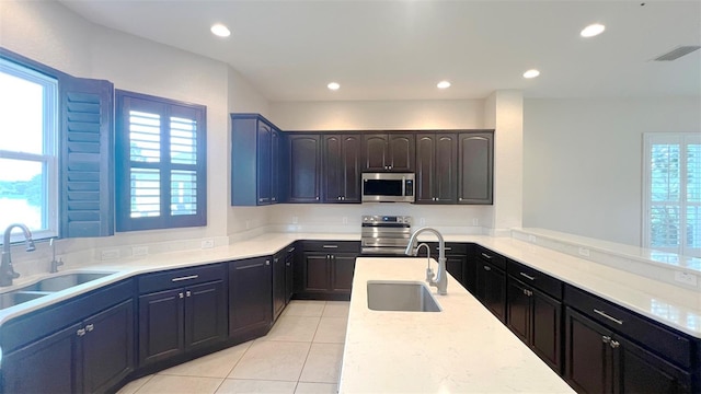 kitchen with stainless steel appliances, plenty of natural light, and sink