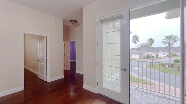 entryway with dark hardwood / wood-style floors, plenty of natural light, and french doors