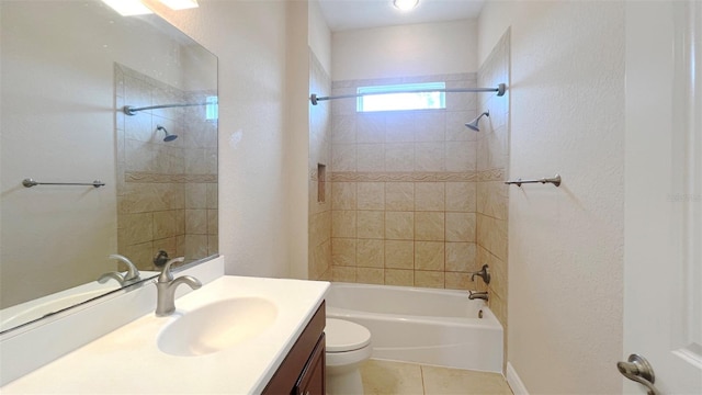 full bathroom featuring tile patterned flooring, vanity, toilet, and tiled shower / bath