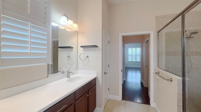 bathroom featuring vanity, hardwood / wood-style flooring, and a shower with door