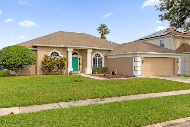 view of front of house with a front yard and a garage