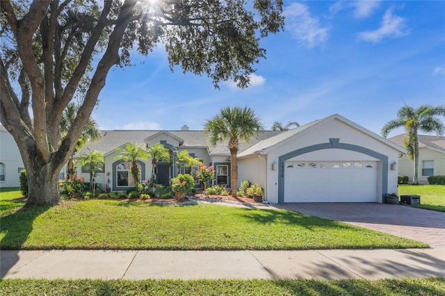 ranch-style house with a garage and a front yard