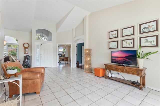 tiled living room with high vaulted ceiling