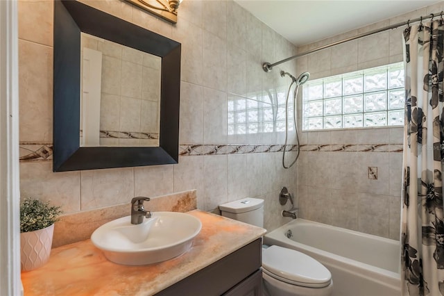 full bathroom featuring vanity, tile walls, shower / tub combo, and toilet