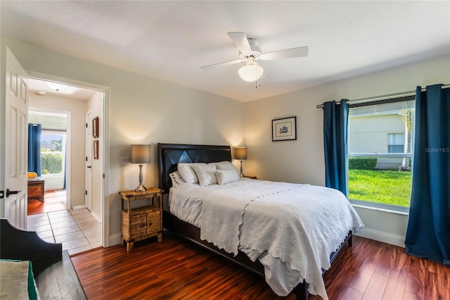 bedroom with ceiling fan and dark hardwood / wood-style flooring