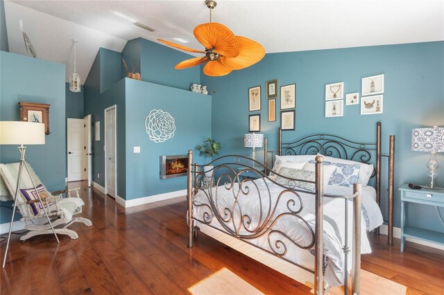 bedroom with vaulted ceiling, wood-type flooring, and ceiling fan