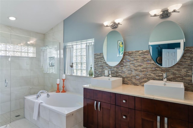 bathroom with lofted ceiling, tile walls, vanity, plus walk in shower, and backsplash