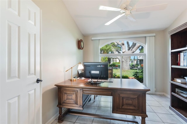 office featuring vaulted ceiling, ceiling fan, and light tile patterned flooring