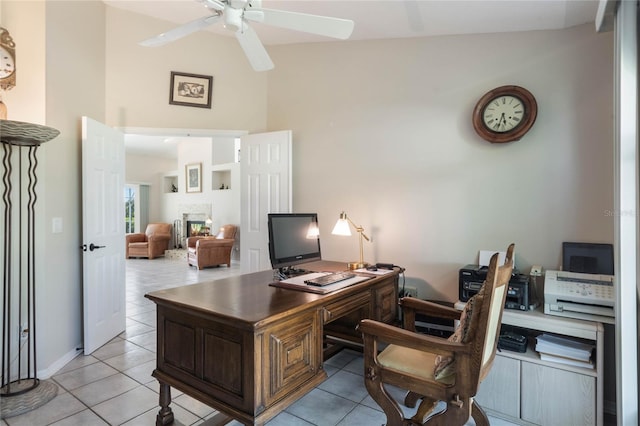 tiled home office with a towering ceiling and ceiling fan