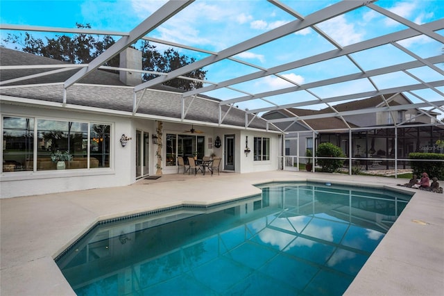 view of swimming pool with a patio and a lanai