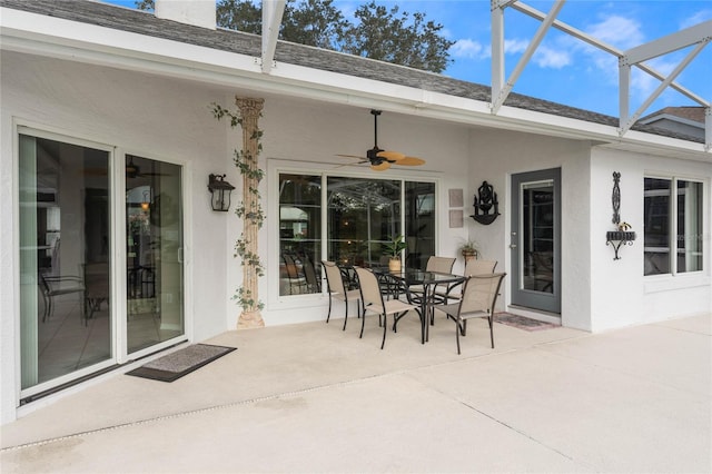 view of patio featuring a lanai and ceiling fan