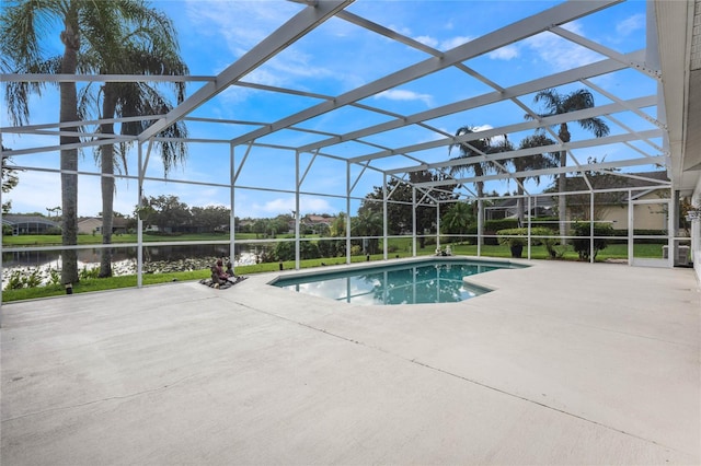 view of swimming pool featuring a patio, a water view, and glass enclosure