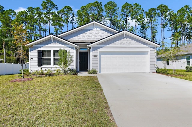 view of front of home with a front lawn and a garage