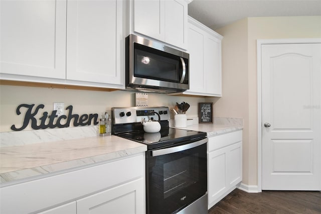 kitchen featuring dark wood-type flooring, white cabinetry, and stainless steel appliances