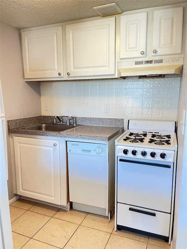 kitchen with tasteful backsplash, white cabinets, white appliances, sink, and extractor fan