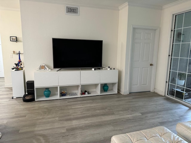 living room featuring crown molding and light hardwood / wood-style floors