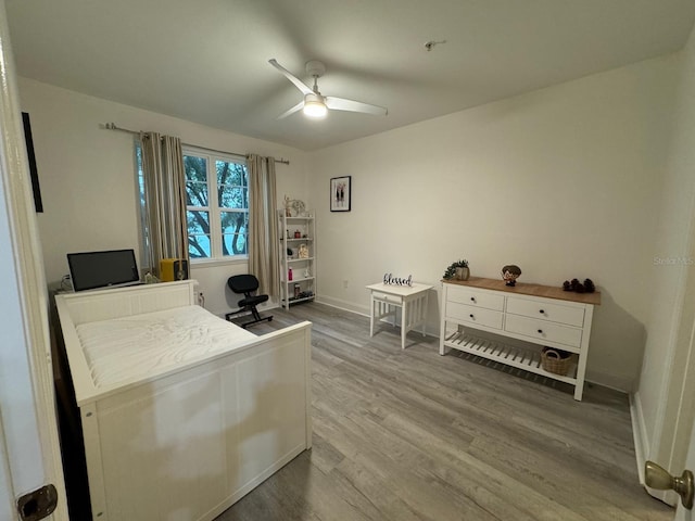 bedroom with wood-type flooring and ceiling fan