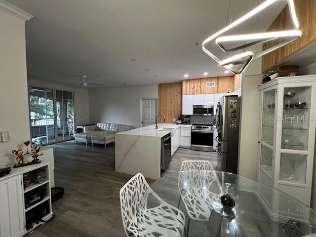 kitchen featuring ceiling fan, sink, white cabinetry, stainless steel appliances, and dark hardwood / wood-style flooring