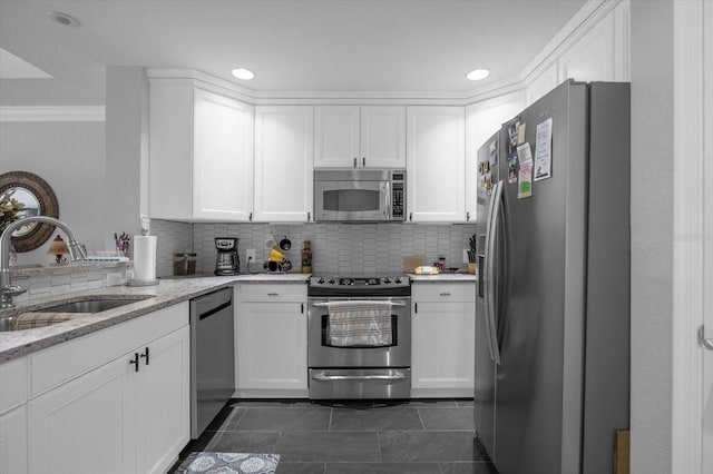 kitchen featuring white cabinets, stainless steel appliances, and sink