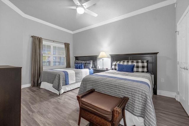 bedroom with ornamental molding, hardwood / wood-style floors, and ceiling fan