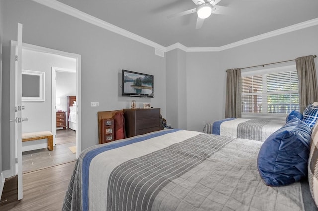 bedroom with ornamental molding, hardwood / wood-style flooring, and ceiling fan