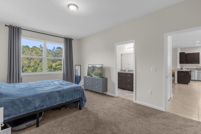 bedroom with light carpet and ensuite bath