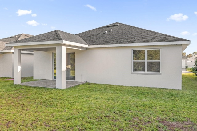 back of house featuring a yard and a patio area