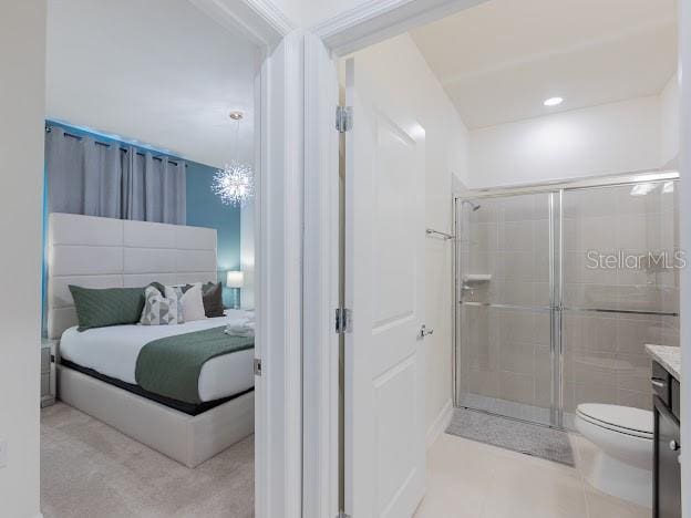 bathroom with toilet, a shower with door, vanity, and a chandelier