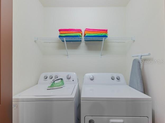 clothes washing area featuring washing machine and clothes dryer