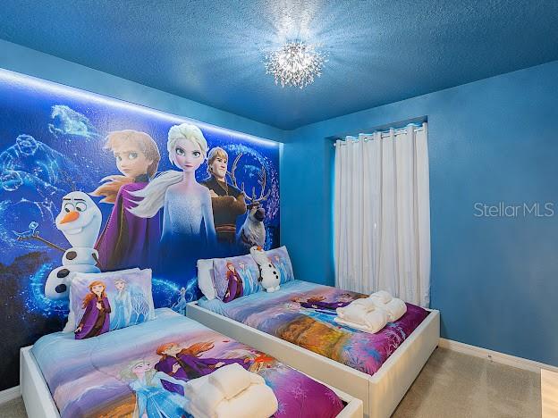 carpeted bedroom with a textured ceiling