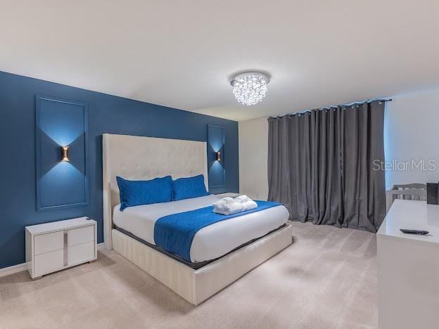 bedroom with a notable chandelier and carpet