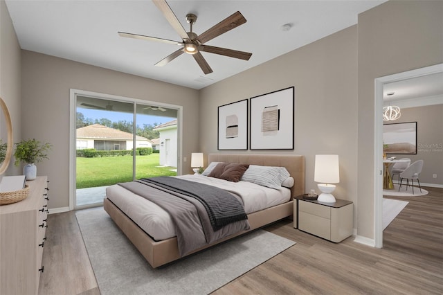 bedroom featuring access to outside, light hardwood / wood-style flooring, and ceiling fan