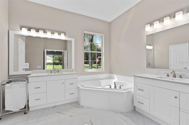 bathroom featuring vanity and tiled bath