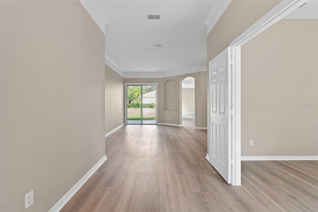 corridor featuring ornamental molding and light hardwood / wood-style flooring