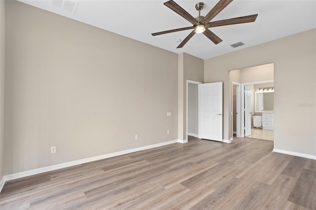 unfurnished bedroom with ceiling fan, ensuite bathroom, and light hardwood / wood-style floors