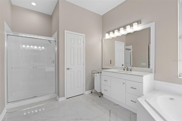 bathroom featuring vanity and independent shower and bath