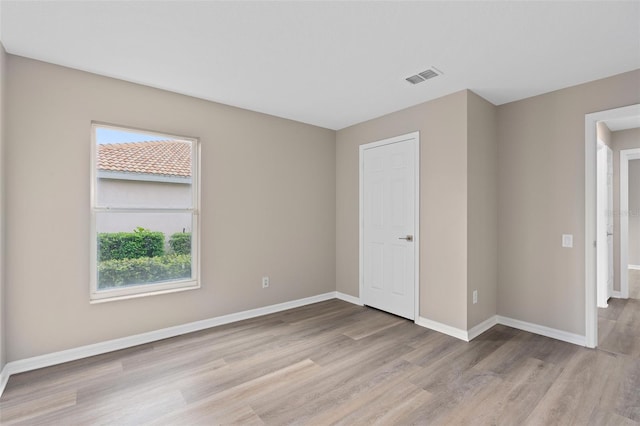 unfurnished room with light hardwood / wood-style floors