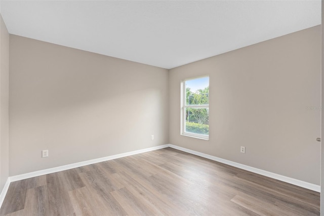 unfurnished room with light hardwood / wood-style floors