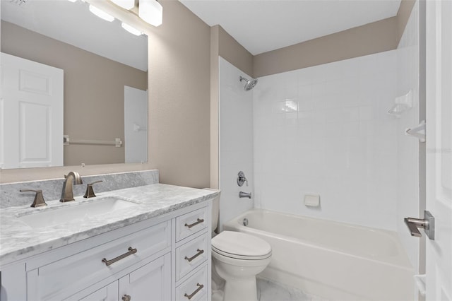 full bathroom featuring tiled shower / bath, vanity, and toilet