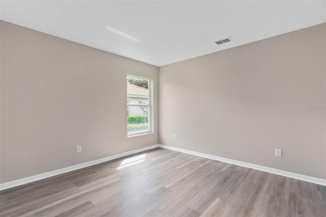 spare room with light wood-type flooring