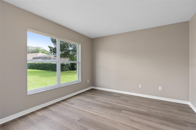 empty room with hardwood / wood-style floors