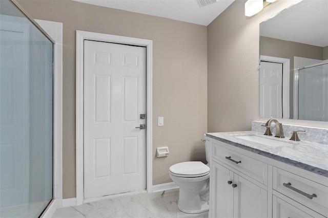 bathroom featuring toilet, a shower with door, and vanity