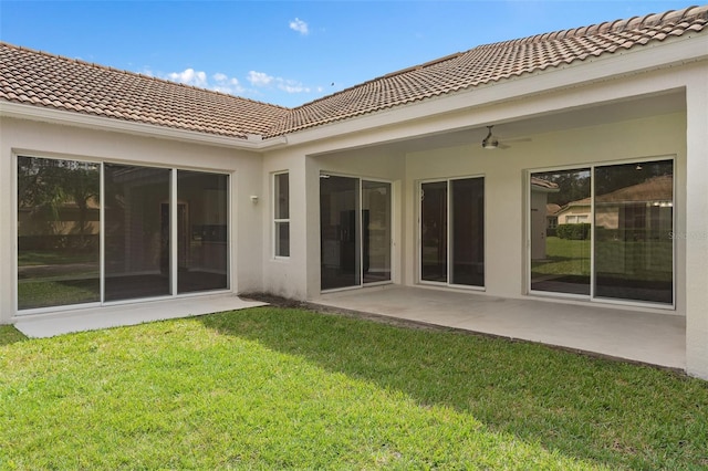 rear view of house featuring a yard, a patio area, and ceiling fan