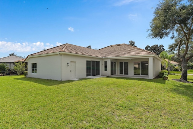 rear view of house featuring a lawn