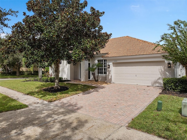 view of front of property with a garage and a front lawn